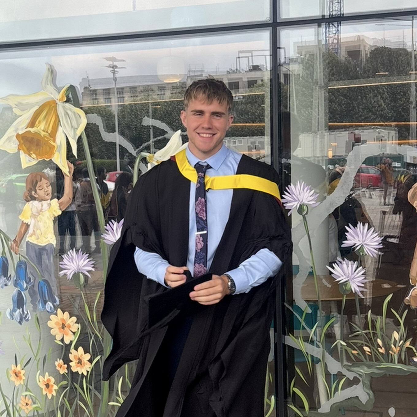 Evan, founder of Deignan Digital, smiling at his graduation